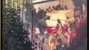 This image grab from a UGC video posted on Nov. 1, 2022, reportedly shows security forces trying to enter a closed shopping center on Amir Kabir street in Iran's capital Tehran before being engulfed by gas matter. 