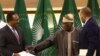 Former Nigerian president and African Union envoy Olesegun Obasanjo gestures to Ethiopian government representative Redwan Hussien and Tigray delegate Getachew Reda, in Pretoria , South Africa, Nov. 2, 2022. 