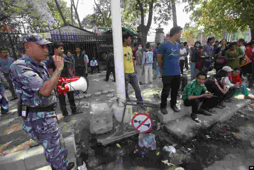 A policeman directs the public to safer areas after an earthquake hit Kathmandu, May 12, 2015.