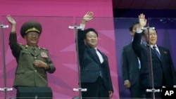 North Korean officials, including National Defense Commission Vice Chairman Hwang Pyong So, left, wave as their team marches into the stadium during the closing ceremony of the 17th Asian Games in Incheon, South Korea, Oct. 4, 2014.