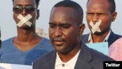 Secretary-general of the Somali Journalists Syndicate Abdalle Ahmed Mumin, center, is seen in an undated photo from his Twitter.