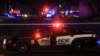 Seorang petugas polisi duduk di dalam kendaraan mereka di klub malam gay Club Q di Colorado Springs, Colorado, AS, 20 November 2022. (Foto: REUTERS/Kevin Mohatt)
