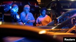 Memphis police officers work at one of multiple crime scenes they believe were committed by a man driving around shooting in Memphis, Tennessee. Sept. 7, 2022. (USA Today Network via Reuters)