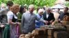 FILE - Britain's Prince Charles, Prince of Wales, center, looks at regional products as he visits the organic farm Herrmannsdorfer Landwerkstaetten in Glonn, southern Germany, on May 10, 2019.