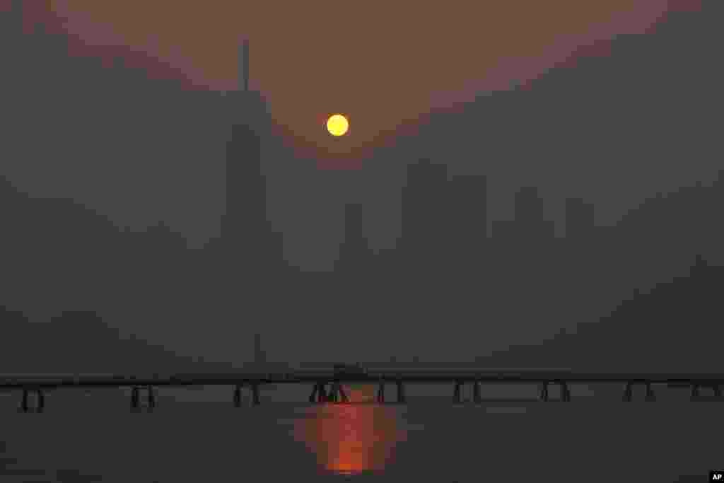 The sun rises over the lower Manhattan skyline as seen from Jersey City, New Jersey, June 8, 2023. Intense Canadian wildfires are blanketing the northeastern U.S. in a dystopian haze, turning the air acrid, the sky yellowish gray and prompting warnings for vulnerable populations to stay inside.