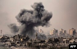This image taken from the Israeli border with the Gaza Strip on Oct. 29, 2023, shows a black cloud of smoke ascending from the Gaza Strip amid the ongoing battles between Israel and the Palestinian group Hamas.