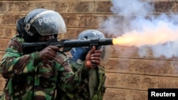 A riot police officer fires tear gas at protesters opposing the imposition of tax hikes by the government in Nairobi, Kenya, July 19, 2023.