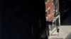 FILE - A masked pedestrian walks through downtown Toronto, Canada, Sept. 10, 2021. 