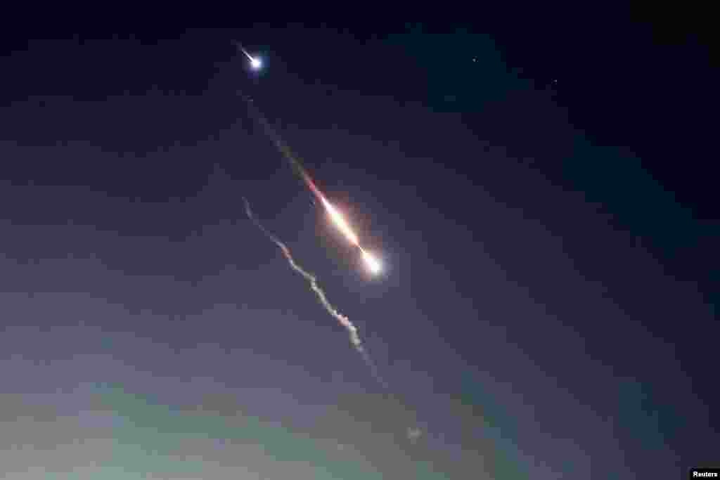 Objects are seen in the sky above Jerusalem after Iran launched drones and missiles towards Israel, in Jerusalem, April 14, 2024.