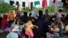 Pengungsi Rohingya beristirahat di gudang pelabuhan yang digunakan sebagai tempat penampungan sementara di Sabang, provinsi Aceh, 7 Desember 2023. (REUTERS/Riska Munawarah)