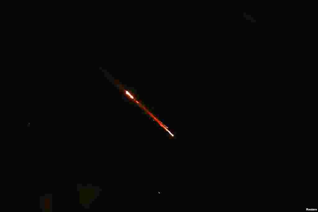 Objects are seen in the sky above Jerusalem after Iran launched drones and missiles towards Israel, in Jerusalem, April 14, 2024. 