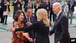 U.S. President Joe Biden, far right, and first lady Jill Biden greet, second from right, greet Japanese Prime Minister Fumio Kishida, second from the left, and his wife Yuko Kishida upon their arrival at the White House in Washington, April 9, 2024