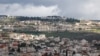 A picture taken in the village of Turmus Ayya near Ramallah city shows the nearby Israeli Shilo settlement in the background, in the occupied West Bank on Feb. 18, 2024. 
