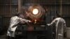 A worker takes a sample for testing as molten gold is poured into bars at the Akara Resources' Chatree gold mine in Thailand's Phichit province, March 23, 2023.