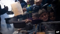Palestinians line up for a free meal in Rafah, Gaza Strip, Feb. 16, 2024. 