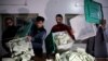 FILE - Election workers empty ballot boxes after polls closed at a station during the general election in Lahore, Pakistan, Feb. 8, 2024. No single party succeeded in winning a simple majority in the National Assembly.
