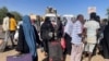 People gather at the station to flee from Khartoum during clashes between the paramilitary Rapid Support Forces and the army in Khartoum, Sudan, April 19, 2023. 