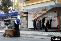 FILE - Afghan beauticians close their beauty salon, as instructed by the Taliban, in Kabul, Afghanistan, July 24, 2023.