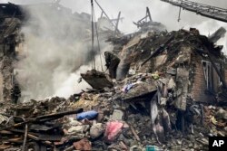 Rrescuers work at the scene of a building damaged by shelling, in Novogrodivka, Ukraine, Nov. 30, 2023. (Donetsk Regional Military Administration via AP)