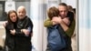 Hostages Fernando Marman, right, and Louis Har, second from left, hug relatives after being rescued from captivity in the Gaza Strip, at the Sheba Medical Center in Ramat Gan, Israel, Feb. 12, 2024.