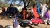 FILE - Families displaced in Muhajiriya, sit at Zamzam IDP camp in North Darfur.