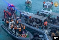 This frame grab from handout video taken on June 17, 2024 shows China coast guard boats (L) approaching Philippine boats (C) during an incident off Second Thomas Shoal. (Armed Forces of the Philippines - Public Affairs Office/AFP)