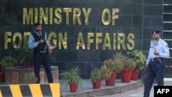 FILE - Pakistani policemen stand guard outside the Pakistan's Foreign Ministry building in Islamabad, Sept. 2, 2019.