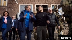 International Atomic Energy Agency Director General Rafael Grossi speaks to Ukraine's President Volodymyr Zelenskyy as they visit Dnipro hydroelectric station, in Zaporizhzhia, Ukraine, March 27, 2023. (Ukrainian Presidential Press Service/Handout via Reuters)