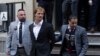 Daniel Penny, center, is walked by New York Police Department detectives detectives out of the 5th Precinct on May 12, 2023, in New York. 