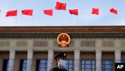 FILE - A Chinese soldier stands guard outside the Great Hall of the People after the opening ceremony of The Third Belt and Road Forum in Beijing, Oct. 18, 2023.
