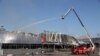 Ukrainian rescuers spray water on a supermarket destroyed as a result of night strike in Odesa, Aug. 14, 2023. Ukraine downed three waves of Russian missiles and drones targeting Odesa, its army said early Aug. 14, 2023.