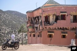 A man stands next to a damaged hotel after the earthquake in Moulay Brahim village, near the epicenter of the earthquake, outside Marrakech, Morocco, Sept. 9, 2023.