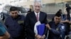 FILE - Journalist Jose Ruben Zamora Marroquin, founder and president of the newspaper El Periodico, is escorted by police officers after being sentenced at a court in Guatemala City, Guatemala, June 14, 2023. 