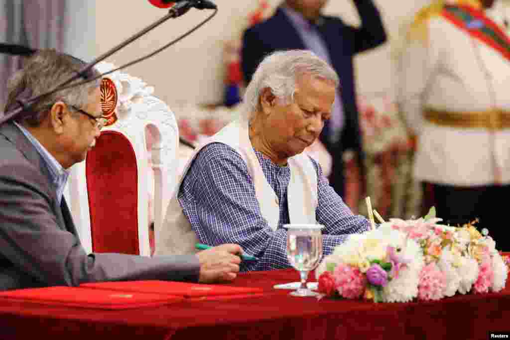 Nobel laureate Muhammad Yunus signs the oath book as the country’s head of the interim government in Bangladesh at the Bangabhaban, in Dhaka.