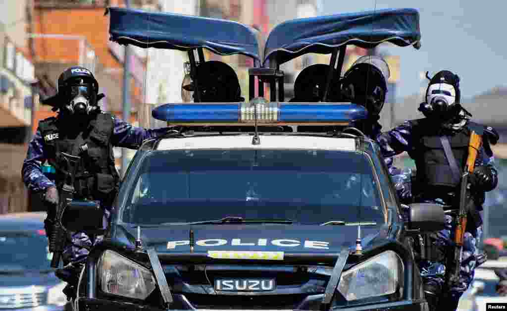 Riot police officers patrol the streets during a rally against what the protesters say are rampant corruption and human rights abuses by the country's rulers in Kampala, Uganda.
