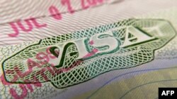 FILE - This photo illustration shows a visa stamp on a foreign passport in Los Angeles on June 6, 2020.