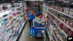 FILE - An employee organizes beauty products inside the Walmart Supercenter in North Bergen, N.J. Feb. 9, 2023.