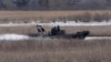FILE - A police boat searches in Akwesasne, Quebec, March 31, 2023. Eight people died last week while attempting a U.S.-Canada border crossing by boat across the St. Lawrence River.