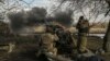 Ukrainian servicemen fire a 105mm Howitzer towards Russian positions, near the city of Bakhmut, March 4, 2023. 