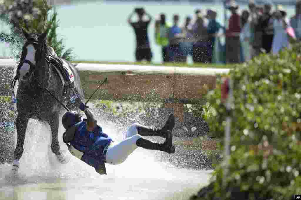 Ecuador's Ronald Zabala G., riding, Forever Young Wundermaske, fall off their horse during the Equestrian Cross Country competition at Chateau de Versailles for the 2024 Summer Olympics, in Versailles, France.