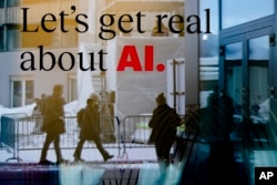 FILE - People are reflected in a window of a hotel at the Davos Promenade in Davos, Switzerland, Jan. 15, 2024. Experts have warned about that artificial intelligence could supercharge the spread of fake news to disrupt the election in the EU and many other countries this year.