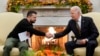 President Joe Biden, right, shakes hands with Ukrainian President Volodymyr Zelenskyy as they meet in the Oval Office of the White House, in Washington, Dec. 12, 2023.