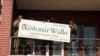 Staff at The Kashmir Walla remove the media outlet's sign from their former office in Srinagar, Indian-administered Kashmir, on Aug. 21, 2023. (Wasim Nabi/VOA)