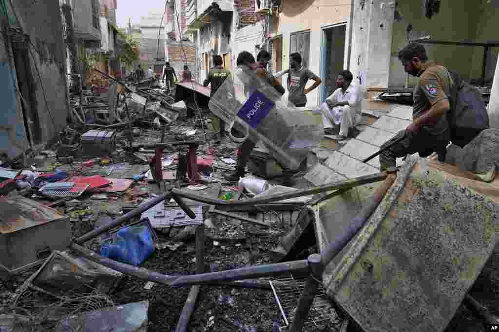 Police officers walk through the rubble of homes vandalized by an angry Muslim mob in a Christian area in Jaranwala in the Faisalabad district, Pakistan, Aug. 17, 2023.