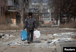 A resident walks on an empty street in the front line city of Bakhmut, Ukraine, as Russia's attack on Ukraine continues, March 3, 2023.