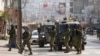 Israeli soldiers take up positions at the scene of a Palestinian shooting attack at the Hawara checkpoint, near the West Bank city of Nablus, Feb. 26, 2023.