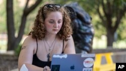 Stella Gage, 19, a sophomore psychology and sociology major at Wichita State University, studies on the campus in Wichita, Kan., Sept. 26, 2023. 