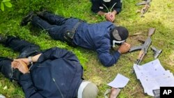FILE - Photo provided by the Serbian Ministry of Interior of three Kosovo police officers captured by Serbian police officers lying face down on a field, June 14, 2023.