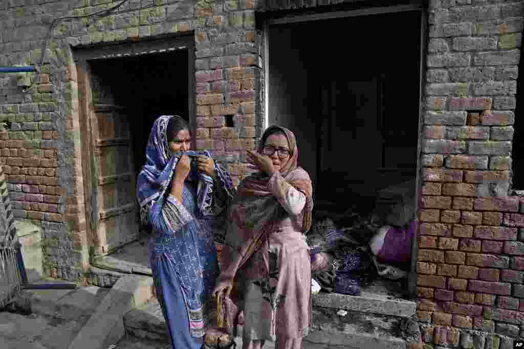 Christian women weep after seeing their homes vandalized by an angry Muslim mob in Pakistan on Aug. 17, 2023.