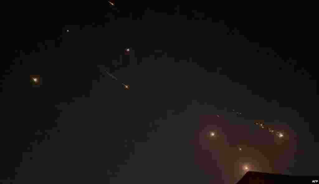 This video grab from AFPTV taken on April 14, 2024 shows explosions lighting up the sky in Hebron in the Israeli-occupied West Bank during an Iranian attack on Israel.